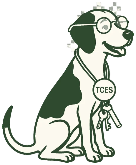 Maisie the dog wearing reading glasses with a Tega Cay Elementary badge and a ring of keys