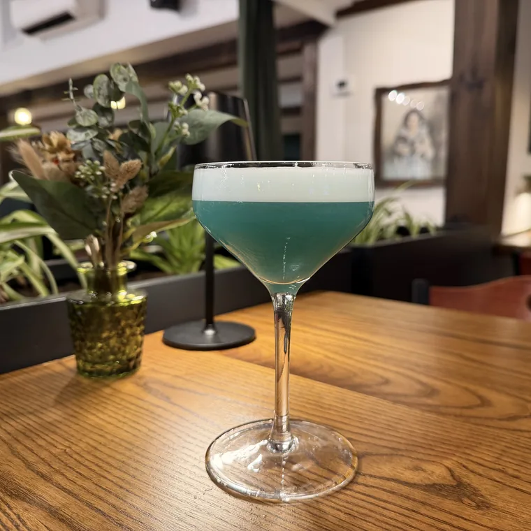 Still Water cocktail with tequila, egg white, honey, lime, and blue curaçao at Maisie’s Green Brae