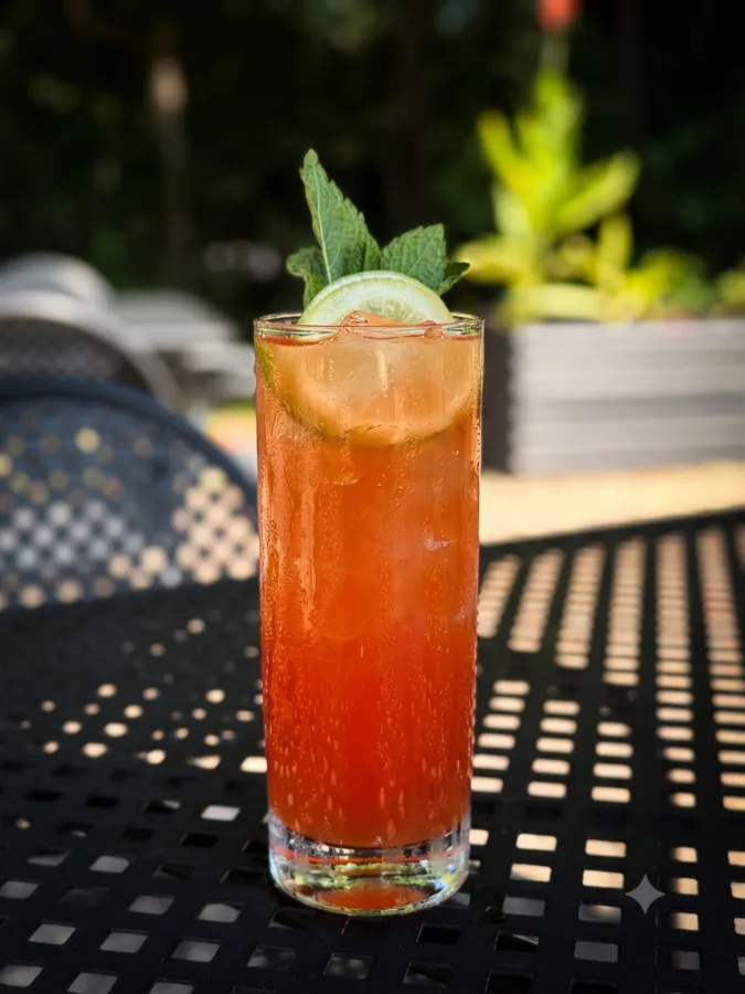The Long Afternoon cocktail with vodka, Aperol, passionfruit, citrus, and mint, served tall over ice at Maisie&rsquo;s Green Brae